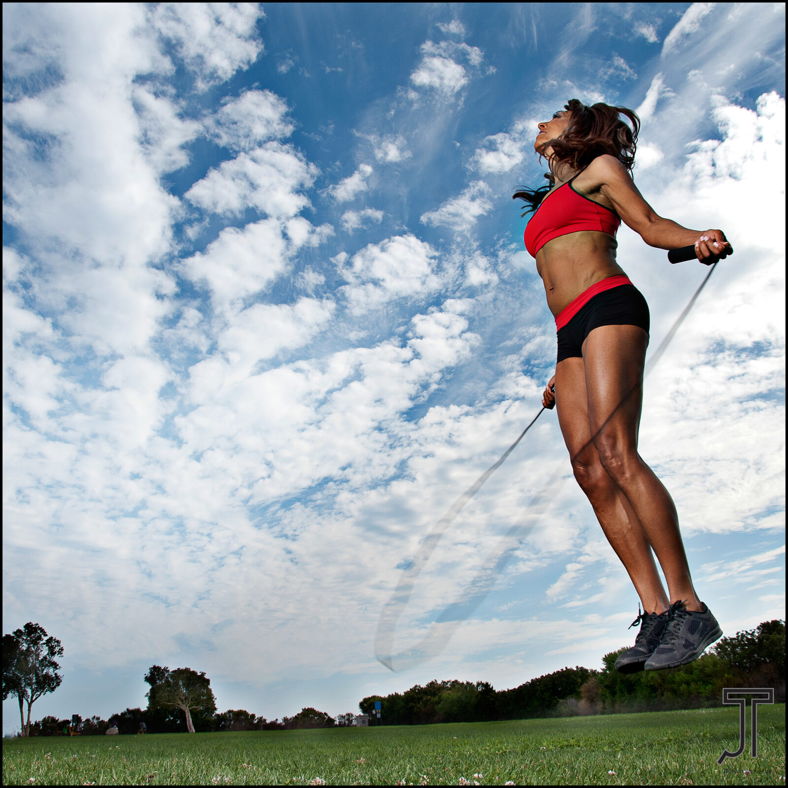 Athlete leaping against a bright blue sky